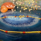 18 karaat gouden armband met rode steentjes