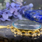 14 karaat gouden hanger met blauwe steen
