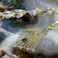 14 karaat gouden hanger met paars steentje